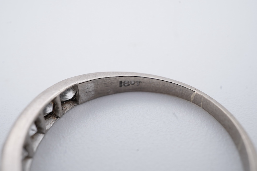 A diamond half eternity ring, set to the front with a sequence of brilliant-cut diamonds totalling approximately 0.80 carats, mounted in white gold, size O1/2, stamped 18CT, gross weight approximately 2.5 grams
